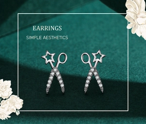 Macro detail of silver scissor-shaped earrings with sparkling star-shaped cubic zirconia