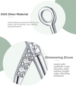 Detailed macro view of S925 sterling silver earrings with prong-set cubic zirconia stones