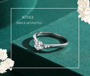 Close-up of S925 sterling silver ring with sparkling round cubic zirconia on green pedestal