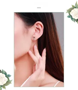 Close-up of s925 silver star scissors stud earrings worn by a model in elegant style