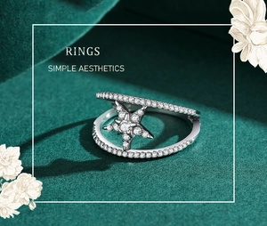 Close-up of S925 sterling silver double-layered star ring with pavé crystals on green velvet
