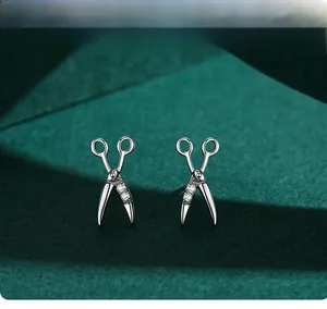 Detail view of S925 sterling silver scissor earrings with sparkling zircon stones