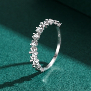Bague marguerite en argent S925 sertie de zircons sur fond de velours vert élégant