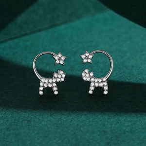 S925 sterling silver cat and star earrings with pavé zircon stones on green velvet