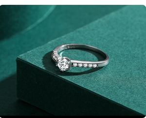 Macro view of S925 sterling silver ring with sparkling round diamond and side stones