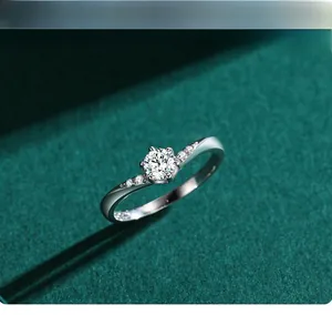 Macro shot of s925 silver ring featuring six-prong moissanite setting on green velvet