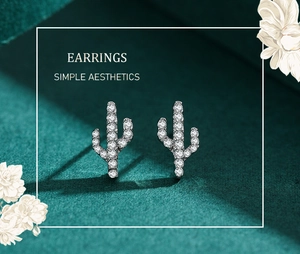 Close-up of S925 silver cactus stud earrings with micro-set diamonds on dark velvet