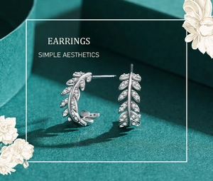 Detail of silver S925 leaf earrings with micro-set sparkling white cubic zirconia stones