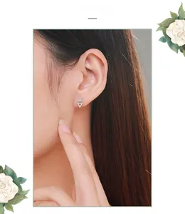 Close-up of a model wearing minimalist S925 silver triangle geometric stud earrings