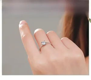 Detailed view of elegant S925 sterling silver four-prong solitaire engagement ring on finger