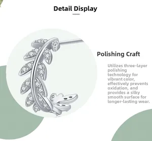 Close-up of S925 silver leaf stud earrings featuring polished zircon inlay details