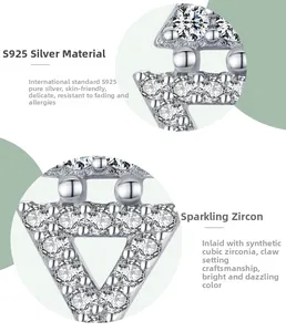Macro detail of S925 sterling silver triangle earrings with claw-set cubic zirconia stones