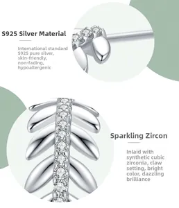 Macro detail of leaf-shaped S925 sterling silver studs with cubic zirconia prong setting