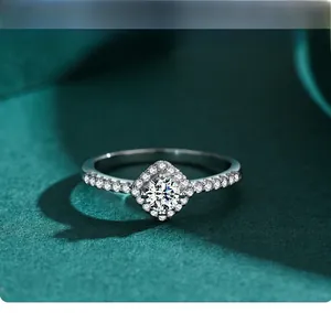 Close-up of S925 silver square halo ring with round zircon inlay on green velvet