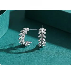 Close-up of S925 sterling silver leaf stud earrings with pavé white zircon details