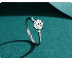 Macro view of six-prong moissanite engagement ring with side stone pavé setting