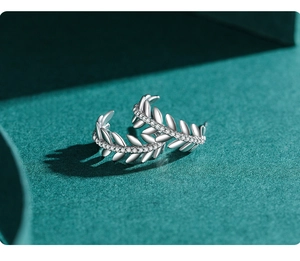 Detailed view of silver leaf earrings with shimmering micro-paved cubic zirconia