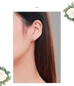 Close-up of S925 sterling silver snake earrings with pavé zircons on a model's ear