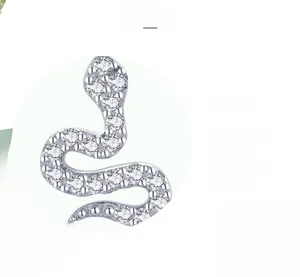 Detailed macro view of S925 sterling silver snake earrings with pavé set white zircon stones