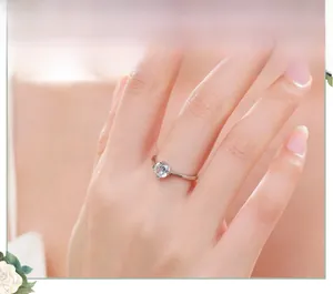 Close-up of minimalist S925 silver solitaire ring with round brilliant cut zircon on hand