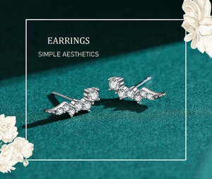 Macro shot of wing-shaped S925 sterling silver stud earrings with sparkling cubic zirconia