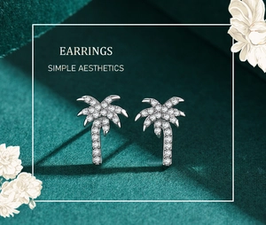Detailed close-up of s925 silver palm tree stud earrings with pavé micro-zirconia