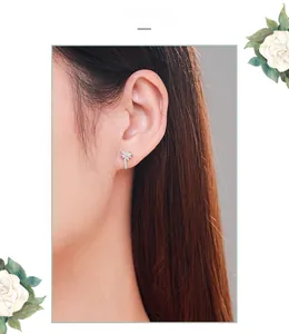 Close-up of s925 silver palm tree stud earrings with sparkling micro zircon on ear