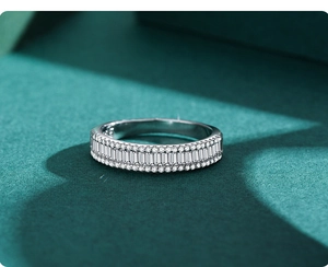 Macro shot of s925 silver ring featuring baguette-cut cubic zirconia and pavé accents