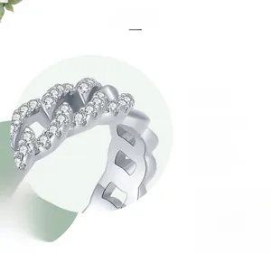 Macro detail of silver Cuban link ring with pavé crystals and polished plating