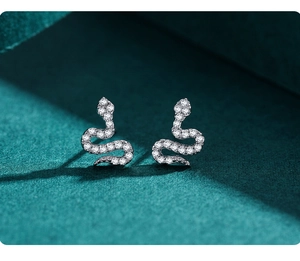 Macro view of S925 sterling silver snake earrings with pavé set zircon crystals