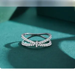 Macro shot of silver X-shaped criss-cross ring with pavé set cubic zirconia stones