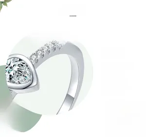 Macro detail of pear-cut silver ring showing three-layer polished finish and side diamonds