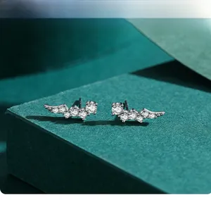 Macro shot of silver S925 stud earrings with sparkling irregular zircon stone details