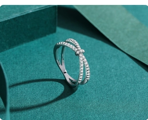 Close-up of S925 silver double row cross ring with pavé-set shimmering zircon stones