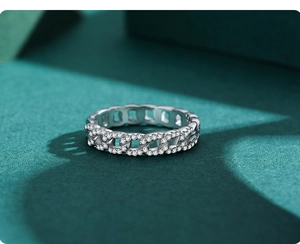 Macro detail of silver Cuban chain ring with half-pave sparkling zircon stones