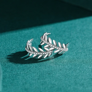 Elegant S925 sterling silver olive leaf stud earrings with pavé crystals on green background