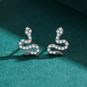 Elegant S925 sterling silver snake earrings with pavé crystals on green texture