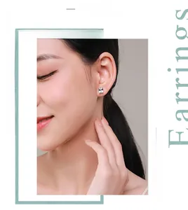 Close-up of rectangle-cut cz stud earrings in 925 silver worn by a model