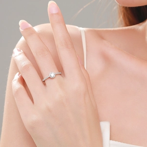 Classic s925 silver halo ring with round cubic zirconia worn on a finger