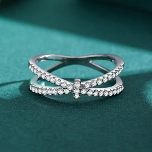 Luxurious S925 silver criss-cross ring with pavé-set zircons on dark green background