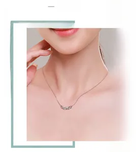 Detail of s925 silver chain necklace featuring three nested rings set with zircons