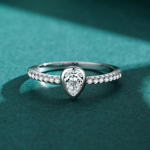 Elegant S925 sterling silver ring with a pear-cut teardrop diamond on a green velvet base