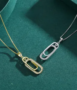 Macro shot of silver and gold interlocking oval pendants with shimmering pavé set zircons