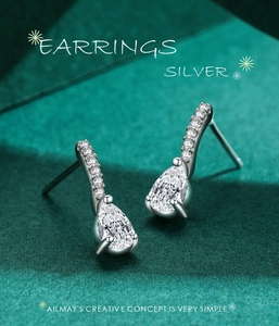 Detail of pear-shaped drop earrings with pavé crystals and sparkling teardrop stone