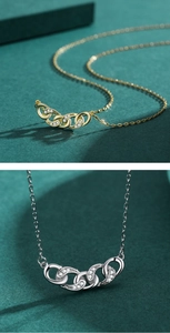 Detail of interlocking oval link pendant with micro zircons in gold and silver finish