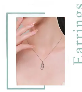 Detail of s925 silver double loop necklace with cubic zirconia pavé on minimalist links