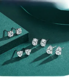 Detail of four S925 sterling silver stud earrings in heart, round, oval, and pear cuts