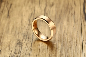 Macro detail of 6mm rose gold tungsten carbide ring with brushed finish and polished interior