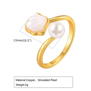 Detail of adjustable brass ring featuring white pearl and seashell design for women