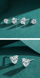 Macro detail of heart and pear-shaped zircon earrings in polished S925 sterling silver